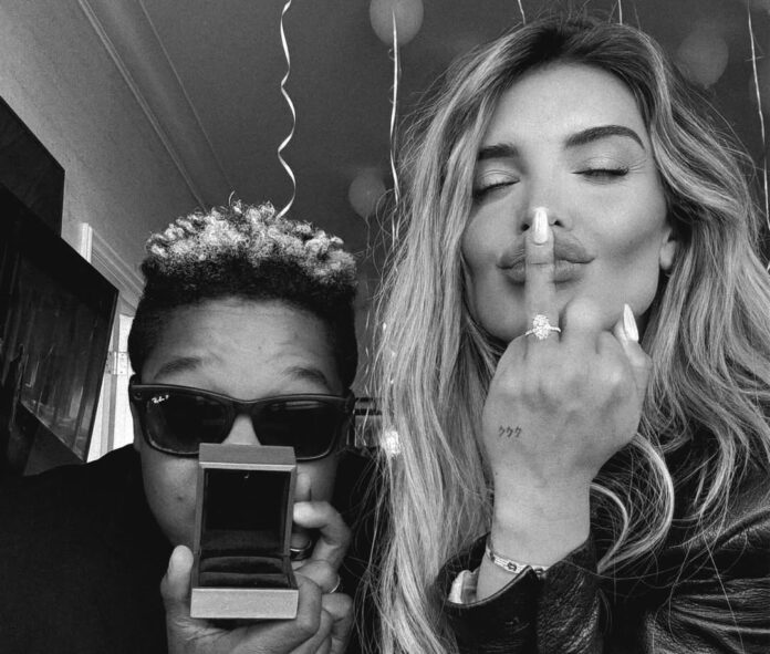 Kyle Massey and Hana Giraldo celebrating their engagement, with Massey holding an open ring box and Giraldo showing off her diamond ring.