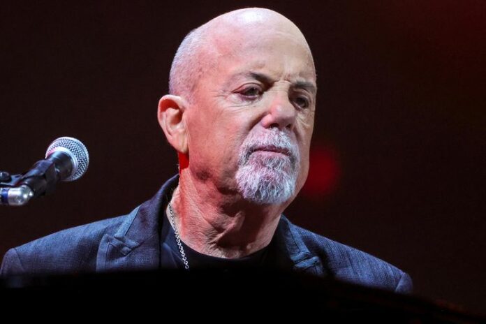 Billy Joel performing live before canceling his tour due to normal pressure hydrocephalus diagnosis.
