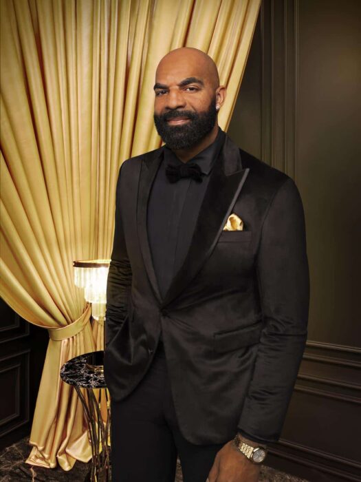 Former NBA star Carlos Boozer smiles confidently in promotional photo for Bravo’s dating series Kings Court.