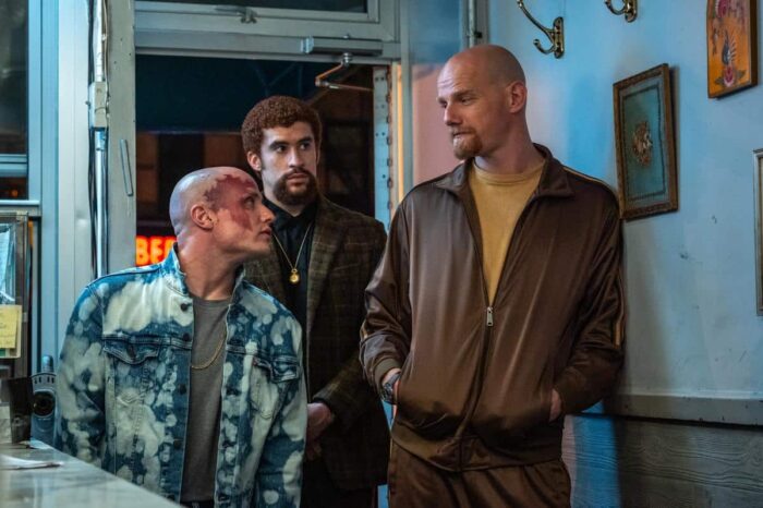 (l to r) Pavel (Nikita Kukushkin), Colorado (Bad Bunny), and Aleksei (Yuri Kolokolnikov) pay a visit to Hank in Caught Stealing.