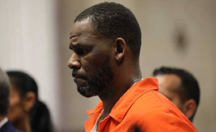 R. Kelly in prison clothing with a serious expression during court appearance