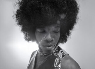 Sly Stone: Music Pioneer & Funk Legend Passes Away At 82 Black and white photo of Sly Stone