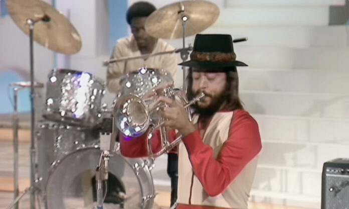 Chuck Mangione performing with his flugelhorn, wearing his signature hat