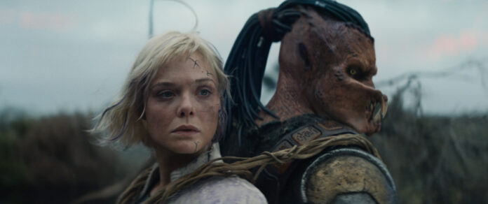 Thia (Elle Fanning) and Dek (Dimitrius Schuster-Koloamatangi) in 20th Century Studios' PREDATOR: BADLANDS film.