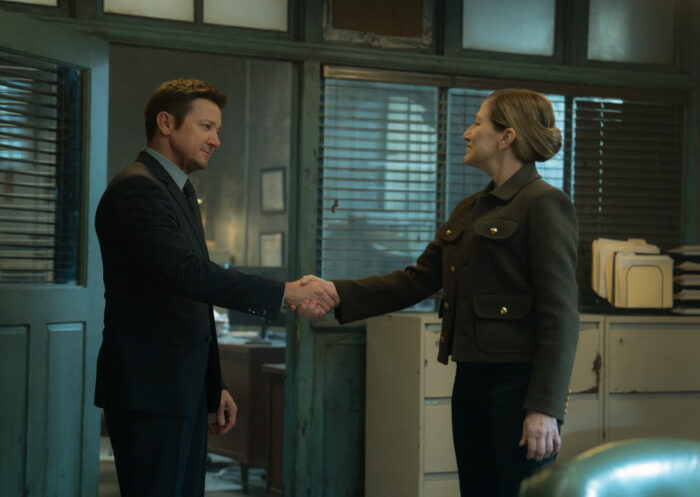Jeremy Renner as Mike McLusky shaking hands with Edie Falco as Nina Hobbs in “Mayor of Kingstown” Season 4 first-look image