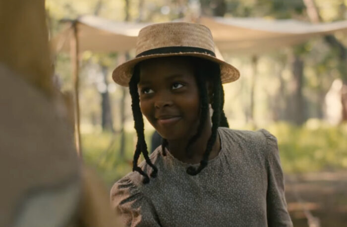 Naya Desir-Johnson as Sarah Rector in the movie Sarah’s Oil, standing confidently on her Oklahoma land