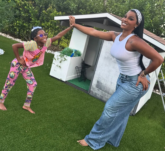 Joseline Hernandez smiles with her daughter Bonnie Bella while dancing in their yard