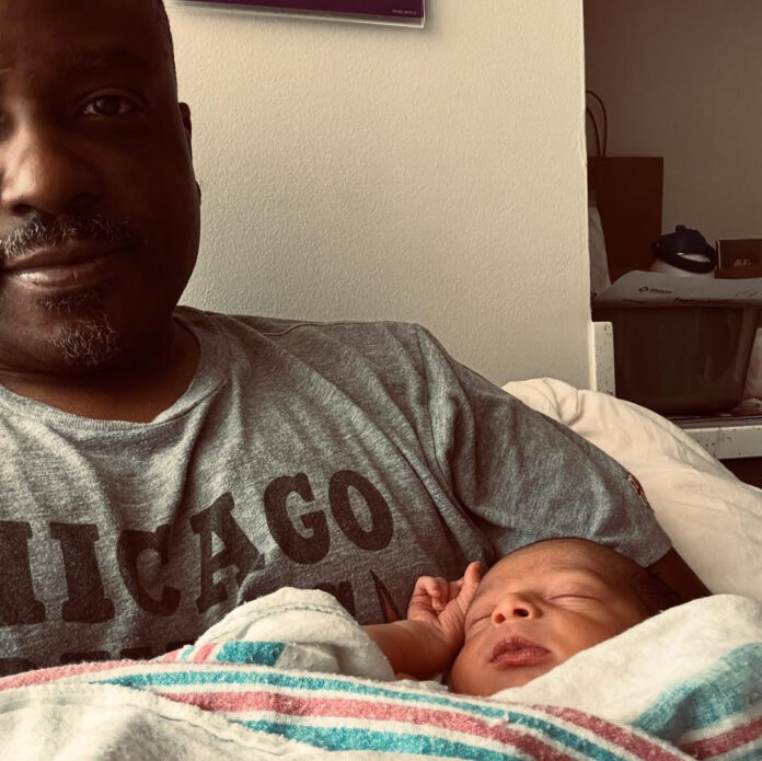 Jason Weaver holds his newborn son River Jeremiah Weaver