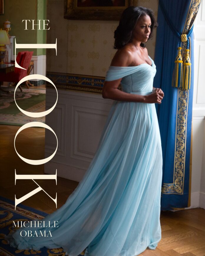 Michelle Obama poses with her book "The Look", now on sale, celebrating fashion, identity, and confidence through powerful personal stories.