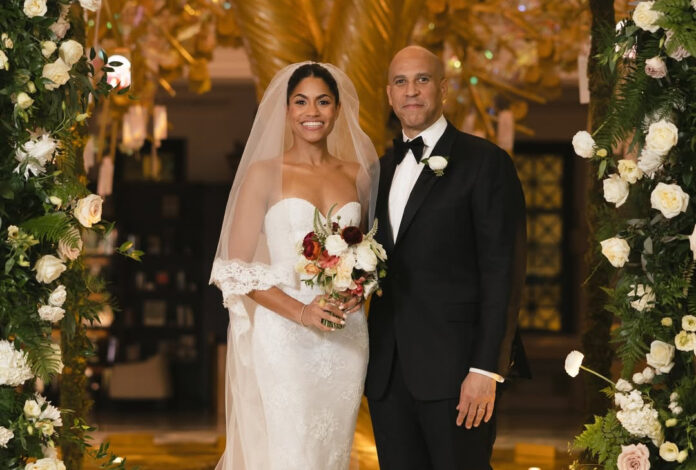 Cory Booker and Alexis Lewis smiling together on their wedding day in Washington DC