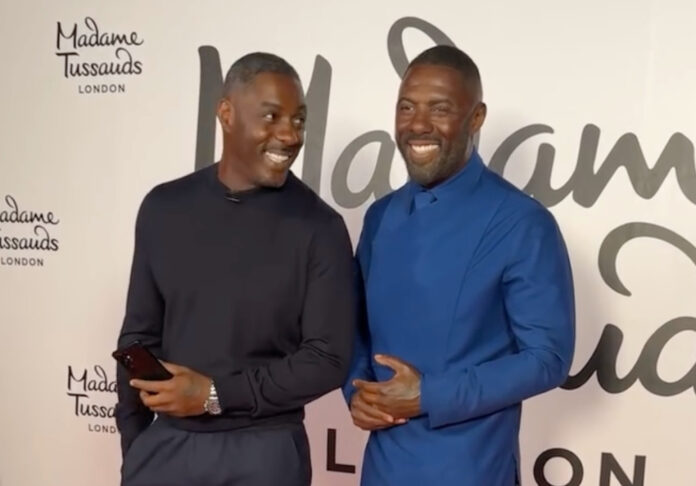 Idris Elba poses next to his first-ever Madame Tussauds wax figure in London, celebrating a full-circle moment from Hackney to Hollywood.