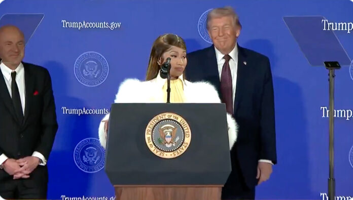 Nicki Minaj speaking at a Treasury Department summit in Washington as President Donald Trump stands nearby during the launch of Trump Accounts.