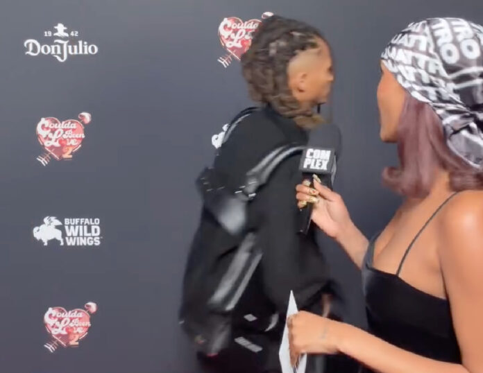 Jaden Smith walking away from a red carpet interview after being asked about his footwear collaboration