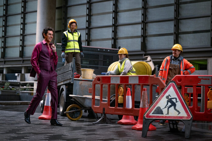 ladies-first-sacha-baron-cohen-damien-sachs-netflix-2026 Sacha Baron Cohen as Damien Sachs in “Ladies First” (2026) on Netflix